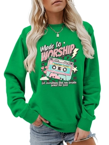 Detail of ribbed neckline and colorful Made to Worship cassette print on green sweatshirt