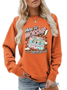 Detail of bright orange sweatshirt with retro cassette tape and worship print design