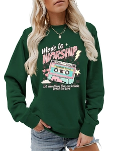 Detail of retro cassette print and Made to Worship text on green crewneck sweatshirt