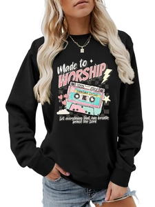 Close-up of retro cassette print and Made to Worship text on black crewneck sweatshirt