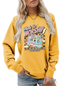 Detail of rib-knit cuffs and vintage tape graphic on mustard yellow worship sweatshirt