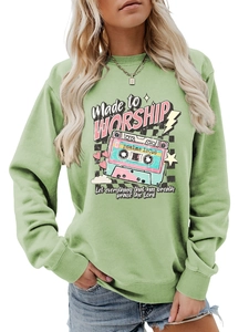 Detail view of the ribbed crewneck and vintage cassette tape print on this green sweatshirt
