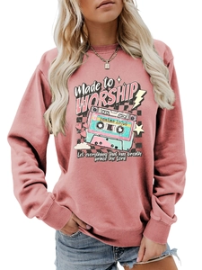 Detail of dusty rose sweatshirt with vintage tape graphic and Made to Worship print