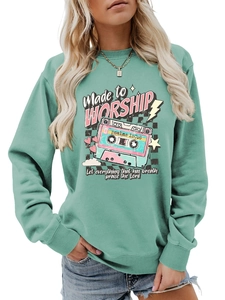 Close-up of the vintage cassette tape graphic and ribbed cuffs on the teal sweatshirt