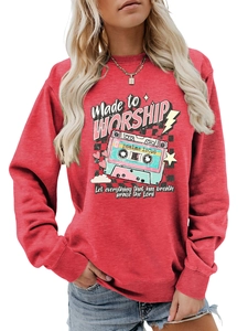 Close-up of red crewneck sweatshirt with retro tape graphic and religious scripture print