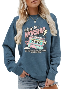 Close-up of the vintage cassette graphic and Made to Worship text on blue sweatshirt