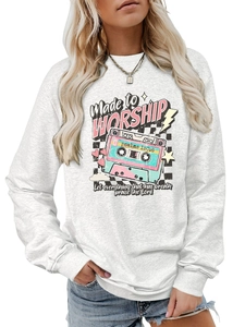 Detail of white crewneck sweatshirt with vintage cassette and Made to Worship print
