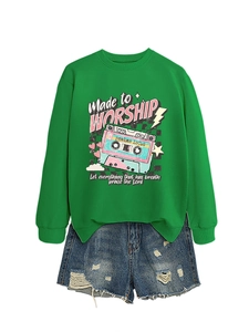 Close-up of bright green sweatshirt featuring vintage cassette and Made to Worship print