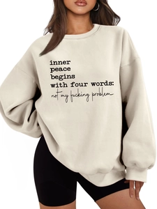 Close-up of beige fleece sweatshirt with inner peace begins with four words print