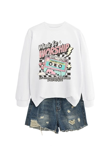 Detail of white sweatshirt with vintage tape print and distressed blue denim shorts