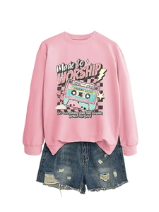 Flat lay of pink sweatshirt with vintage cassette print and blue distressed denim shorts