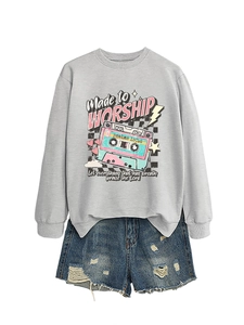 Detail of grey sweatshirt with vintage tape print and distressed denim shorts