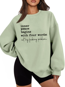 Detail of mint green thick warm fleece sweatshirt featuring inner peace slogan print