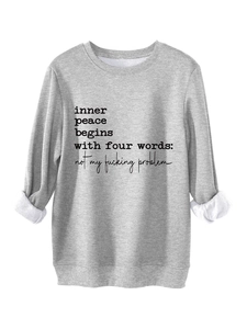 Detail of grey fleece-lined sweatshirt with 'inner peace' text and ribbed sleeve cuff