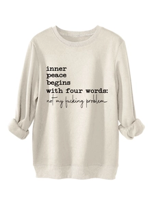 Detail of soft cream sweatshirt fabric with ribbed cuffs and slogan print