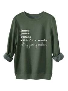 Detail view of dark green fleece sweatshirt showing soft inner texture and slogan print