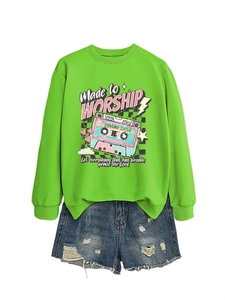 Detail of bright green sweatshirt with 'Made to Worship' vintage cassette tape graphic print