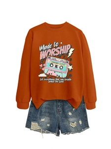 Detail of orange sweatshirt with vintage tape print and distressed denim shorts