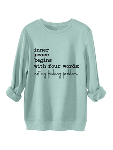 Close-up of ribbed cuffs and slogan print on this thick warm light blue sweatshirt