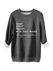 Detail view of thick white fleece lining and slogan print on a charcoal grey sweatshirt