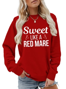Detail of red crewneck sweatshirt featuring white horse icons and sweet text graphics
