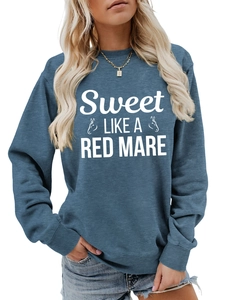 Detail view of blue crewneck sweatshirt with Sweet LIKE A RED MARE artistic print