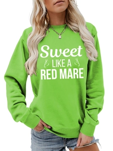 Detail of green crewneck sweatshirt featuring white horse graphic and artistic typography