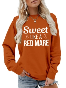 Detail of terracotta sweatshirt showing ribbed crewneck and Sweet Like A Red Mare print