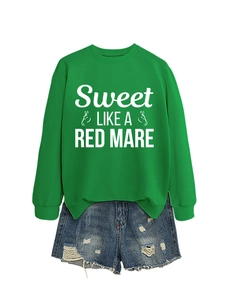 Detail of green crewneck sweatshirt with horse graphic and distressed denim shorts set