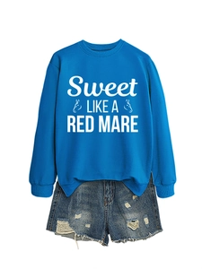 Detail of royal blue sweatshirt with white graphic print and distressed denim shorts