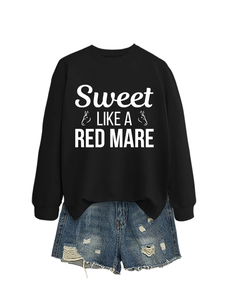 Detailed flat lay of black crewneck sweatshirt with white horse graphic and denim shorts
