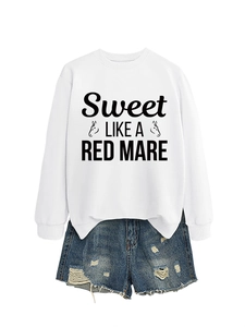 Close-up of white crewneck sweatshirt with Sweet Like a Red Mare print and ripped denim shorts