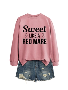 Detail of pink crewneck sweatshirt with Sweet LIKE A RED MARE text and horse graphic