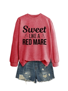 Detail of red crewneck sweatshirt with 'Sweet LIKE A RED MARE' print and denim shorts