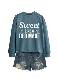 Detail of crewneck sweatshirt with 'Sweet LIKE A RED MARE' print and distressed denim shorts