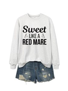 Detail of grey crewneck sweatshirt with horse graphic and distressed denim shorts set