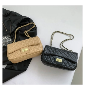 Detail of quilted leather flap bags with gold twist locks and chain straps in black and beige