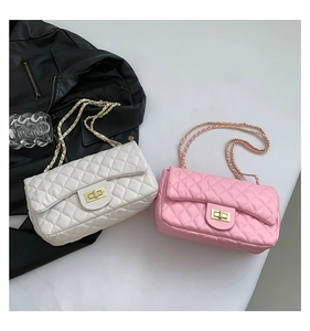 Detailed view of quilted leather texture and golden metal twist lock on the bags