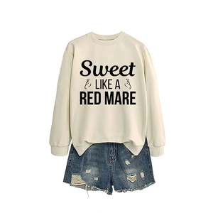 Cream crewneck sweatshirt with Sweet LIKE A RED graphic and distressed denim shorts
