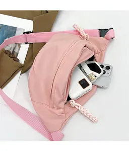 Detail of pink nylon chest bag interior showing space for phone and power bank