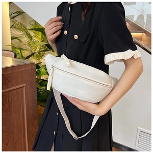 Minimalist white nylon waist bag for women shown as a crossbody pack in indoor setting