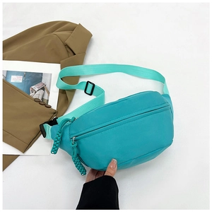 Detail view of bright green nylon waist bag with adjustable strap and buckle closure