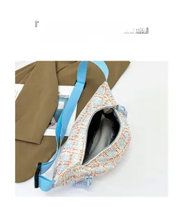 Detail shot of internal compartment in plaid canvas crossbody bag with blue strap