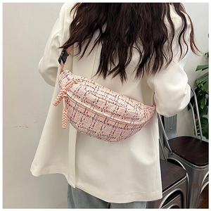 Detail of pink plaid tweed crossbody bag shown on model for a trendy spring look