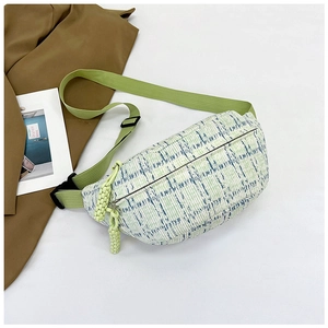 Detailed top view of green checkered tweed waist bag with adjustable strap and zip