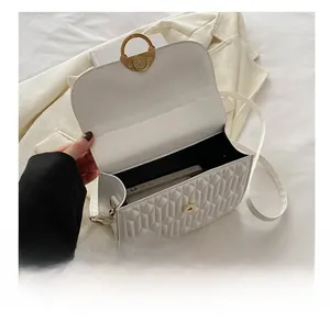Internal capacity of white quilted shoulder bag showing space for a smartphone