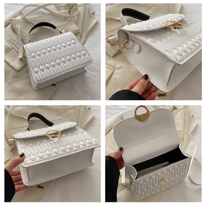 Detail of white quilted texture with gold pearl clasp and elegant interior storage