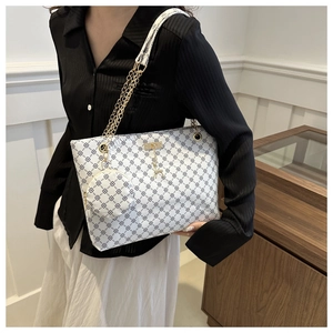 Large white tote bag with black geometric print, gold chain strap, and mini pouch