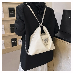Chic cream PU leather multi-way backpack with silver bow accent and metal chain details