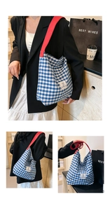 Detail showing the large blue and white plaid tote bag with striking red shoulder straps